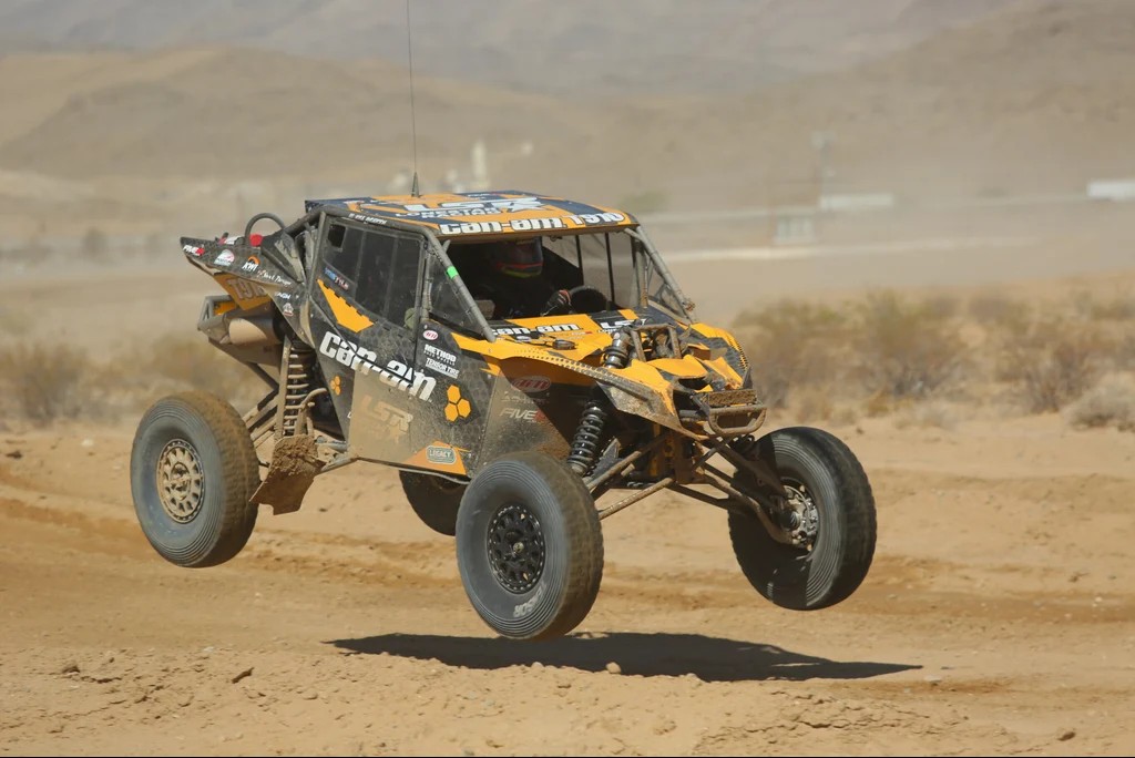 Dan Fisher's Lonestar Racing Can-Am X3 race car catching air in the desert