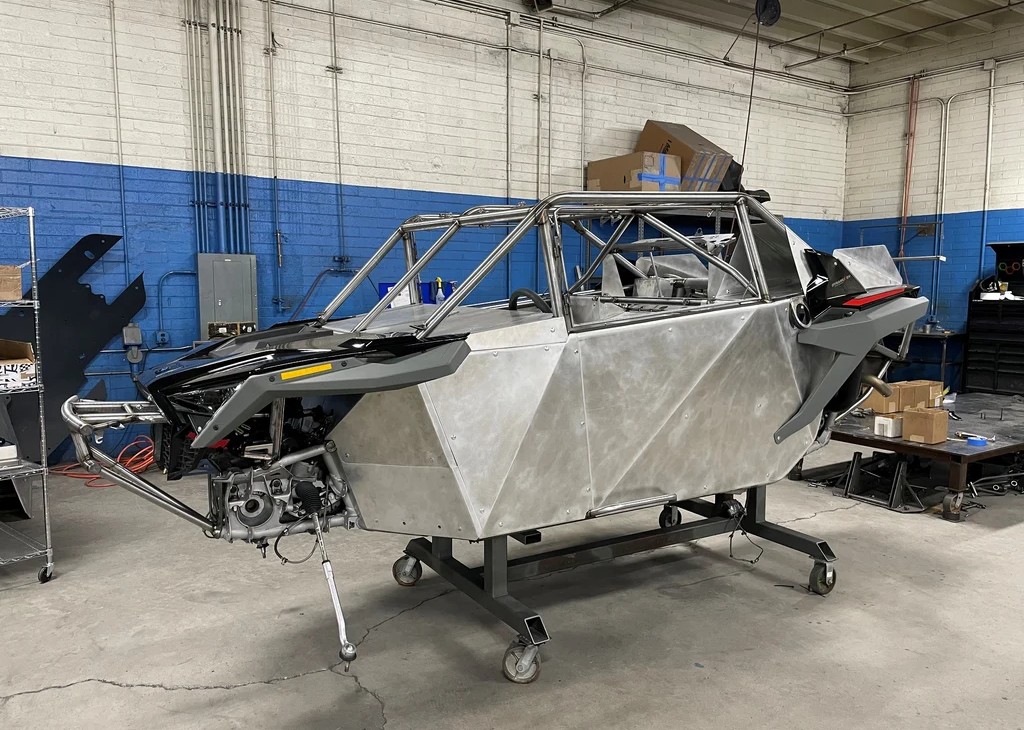 Bare chromoly race chassis under construction in the Lonestar Racing shop
